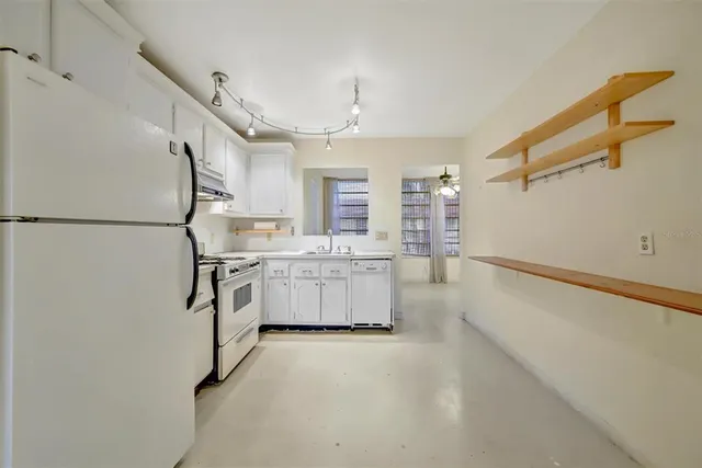 a bathroom with a tub sink vanity granite and a mirror
