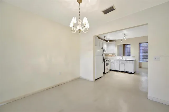 a view of a bedroom with a chandelier swimming pool and windows