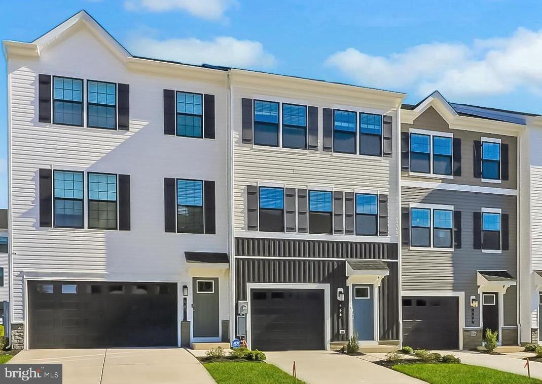 a front view of a building with a garden