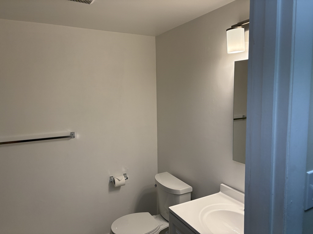 27 Stearns Road, Unit 8 Brookline, MA 02446 - Photo 2 of 9 a white toilet sitting next to a white cabinet