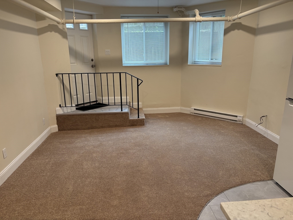 27 Stearns Road, Unit 8 Brookline, MA 02446 - Photo 5 of 9 a view of an empty room with a window