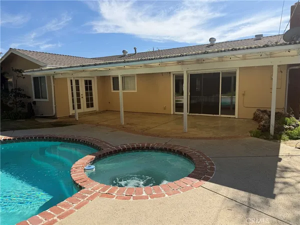a view of a livingroom with a flat screen tv and ceiling fan