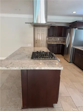 a kitchen with granite countertop a stove and a microwave