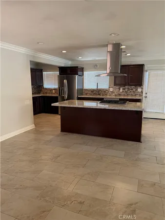 a kitchen with stainless steel appliances granite countertop a refrigerator and a stove top oven