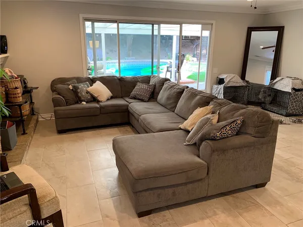 a front view of a house with a yard balcony and swimming pool