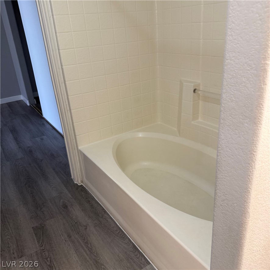 1830 North Pecos Road, Unit 258 Las Vegas, NV 89115 - Photo 9 of 14 Relax in this inviting tub, featuring pristine tile surround and resilient flooring nearby.