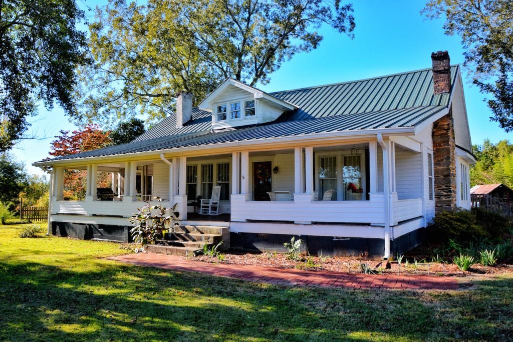 555 Glenloch Road Roopville, GA 30170 - Photo 1 of 1 a front view of a house with swimming pool garden and patio