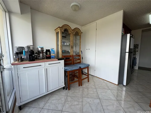 a room with two chairs and a refrigerator