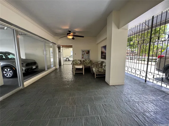a view of a livingroom with furniture hardwood floor and windows
