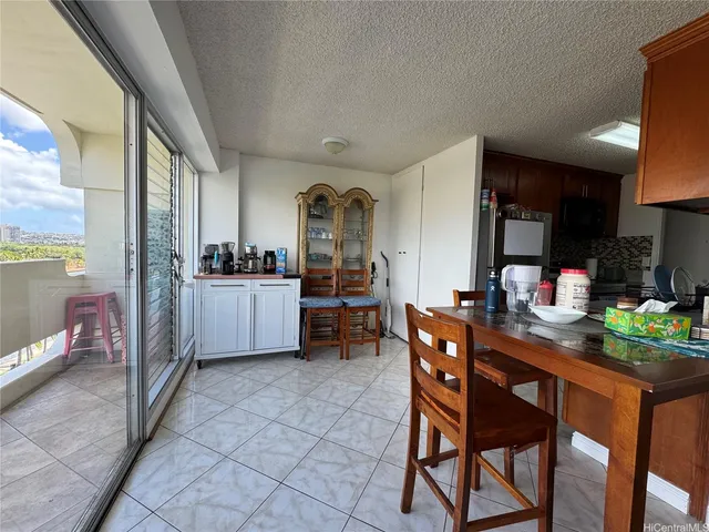 a dining room with furniture and a kitchen view