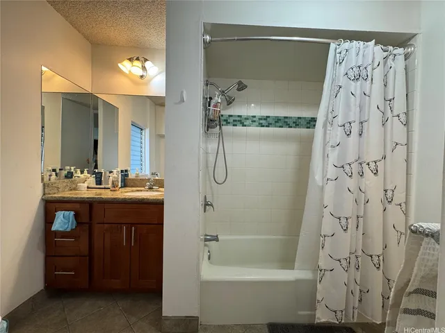 a bathroom with a bathtub sink and mirror