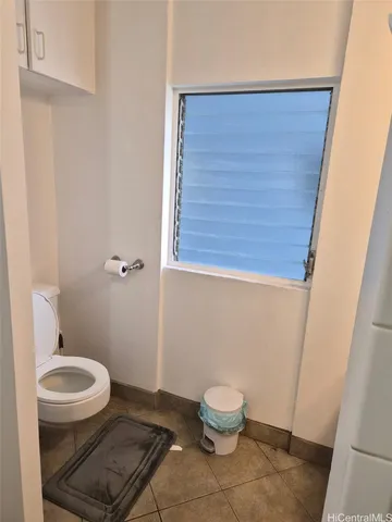 a white toilet sitting next to a small sink