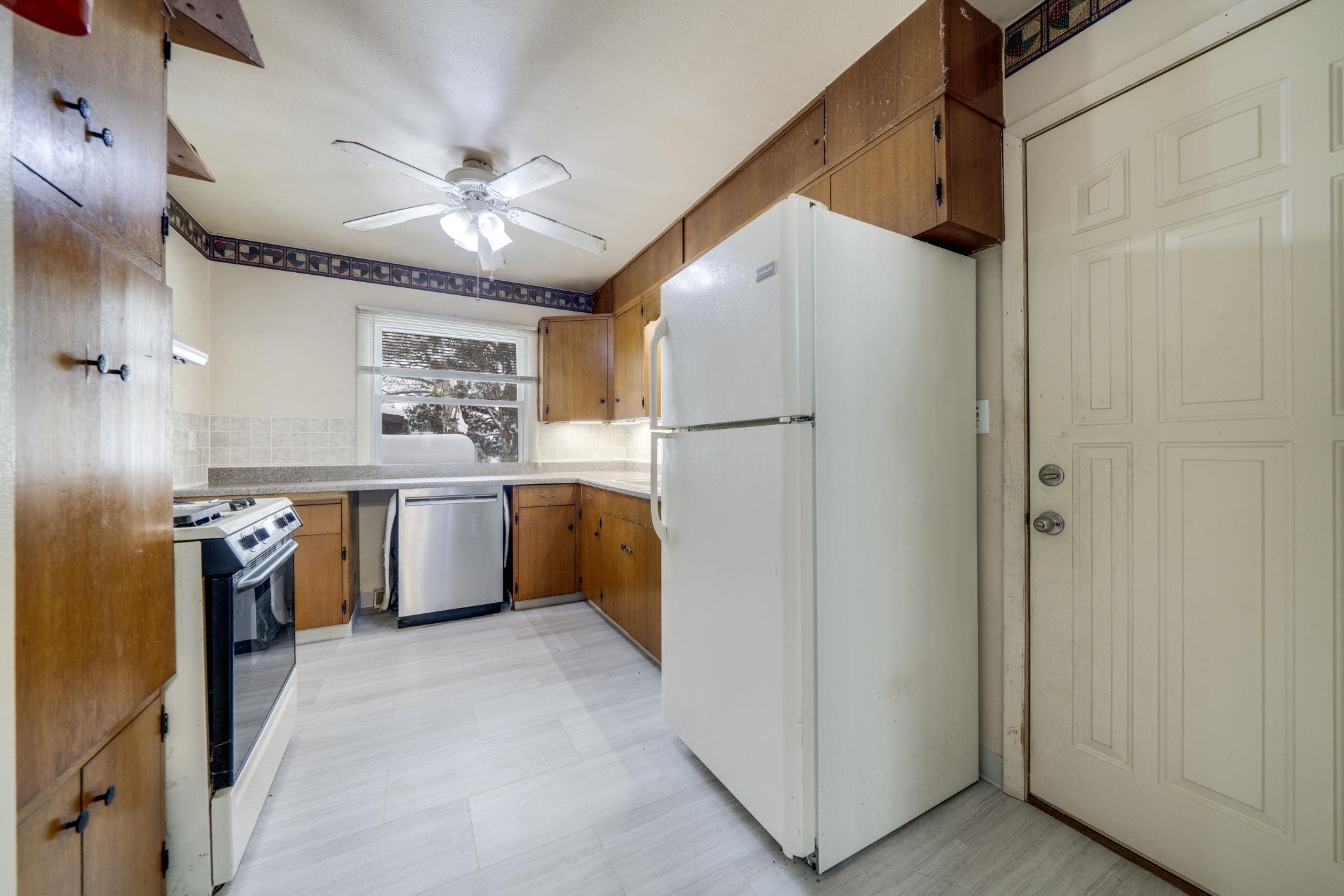 301 Barbara Street Mount Morris, IL 61054 - Photo 16 of 36 a kitchen with a refrigerator a sink and cabinets