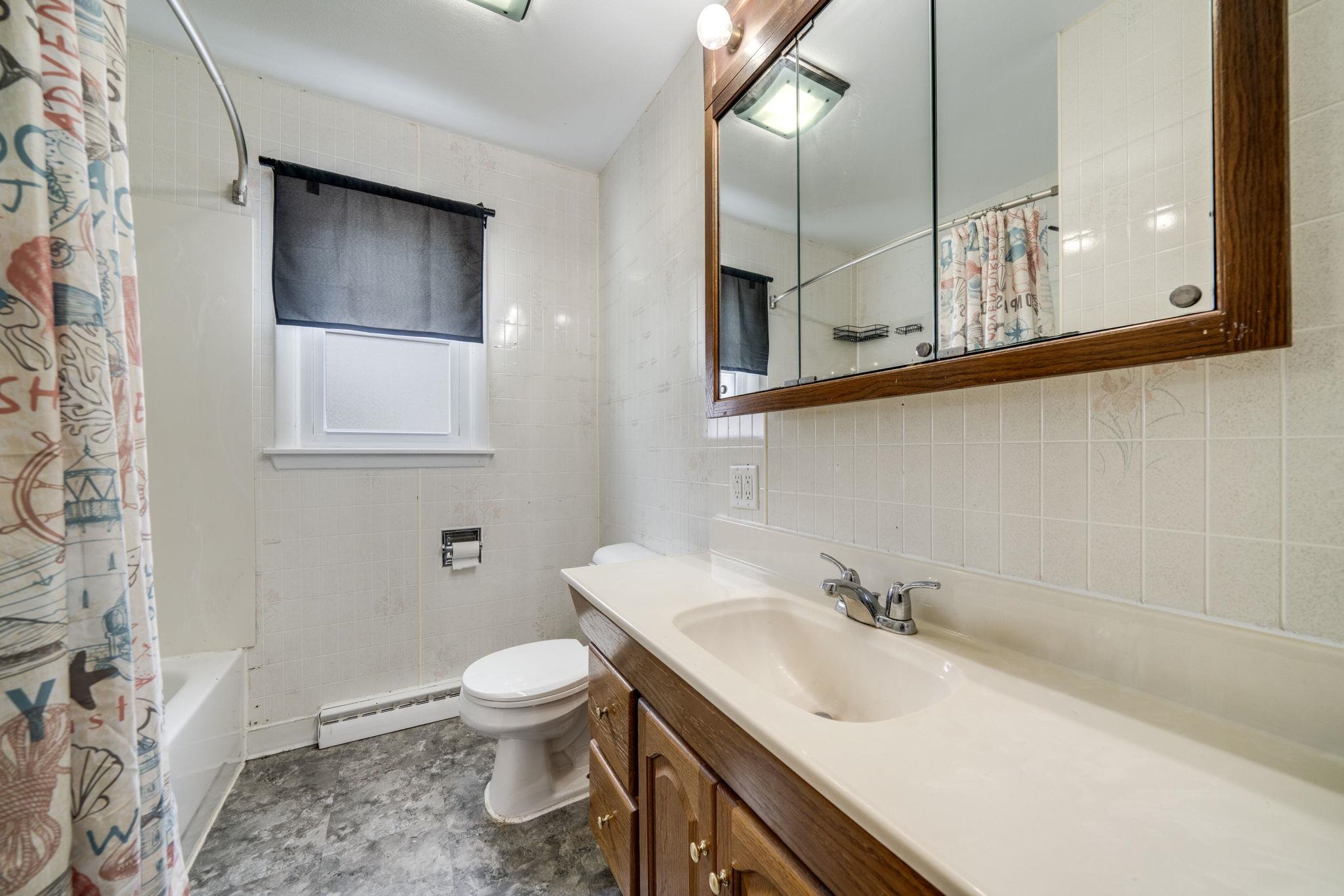 301 Barbara Street Mount Morris, IL 61054 - Photo 22 of 36 a bathroom with a toilet sink and mirror