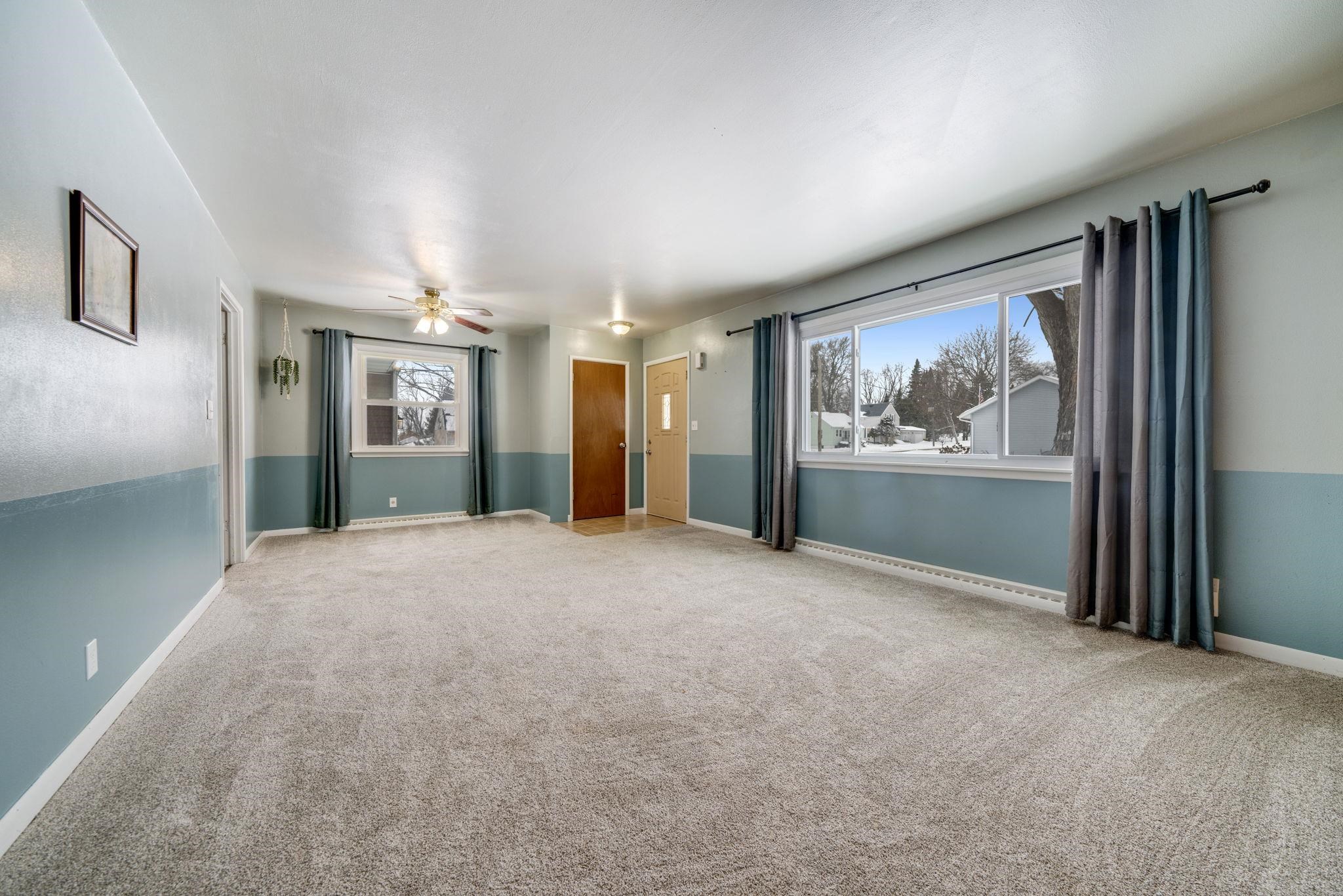 301 Barbara Street Mount Morris, IL 61054 - Photo 4 of 36 a view of a big room with windows and chandelier fan