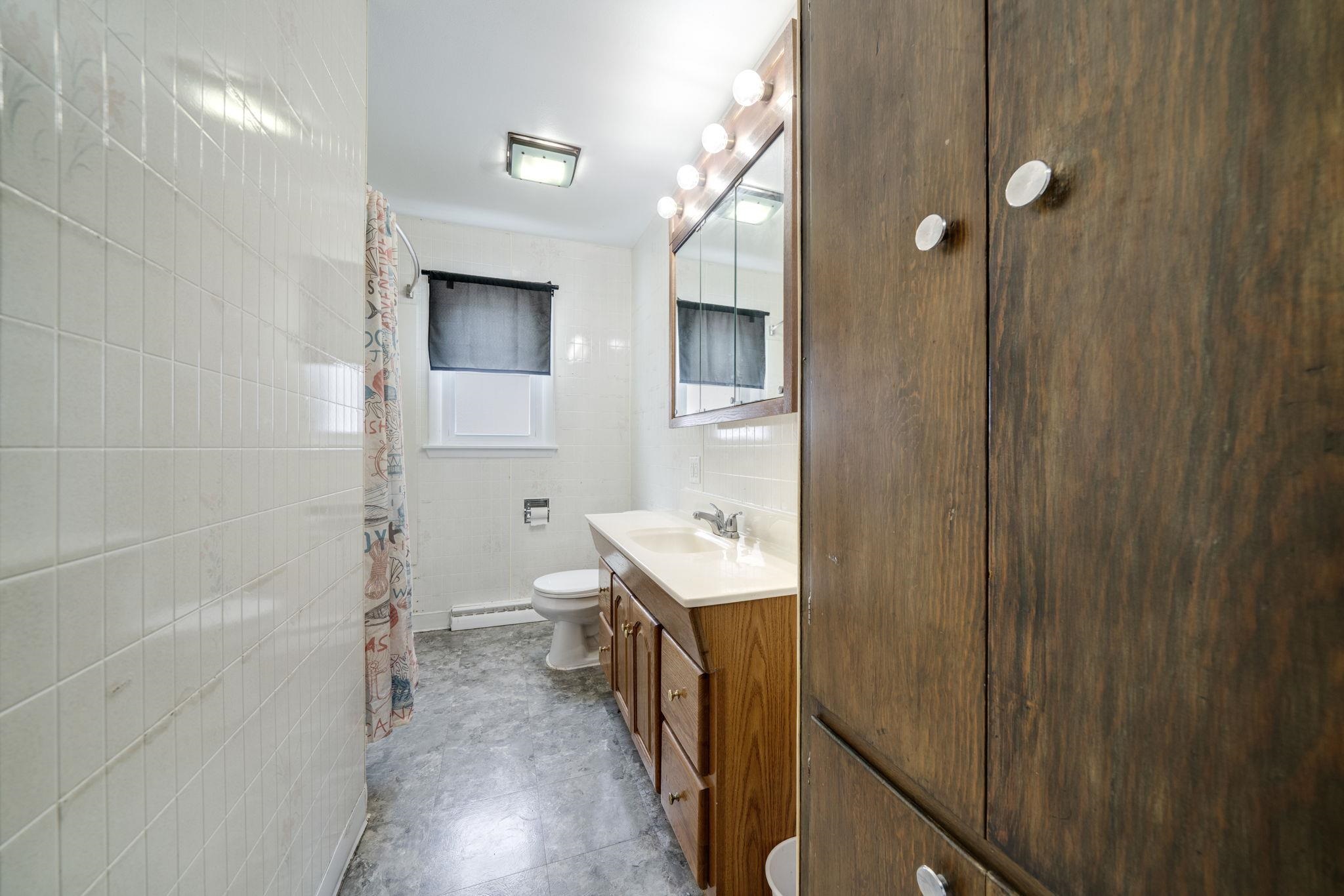 301 Barbara Street Mount Morris, IL 61054 - Photo 5 of 36 a bathroom with a sink a toilet and shower
