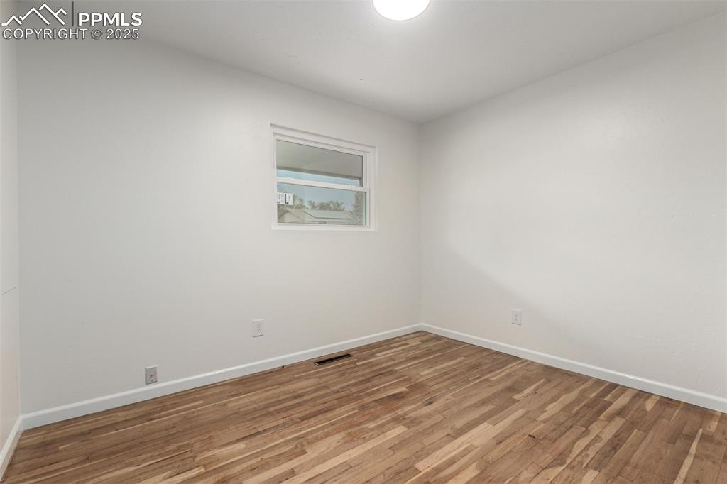 1216 Osgood Road Colorado Springs, CO 80915 - Photo 12 of 36 a view of an empty room with wooden floor