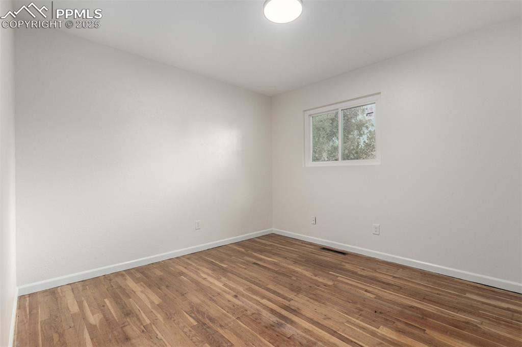 1216 Osgood Road Colorado Springs, CO 80915 - Photo 15 of 36 a view of empty room with wooden floor