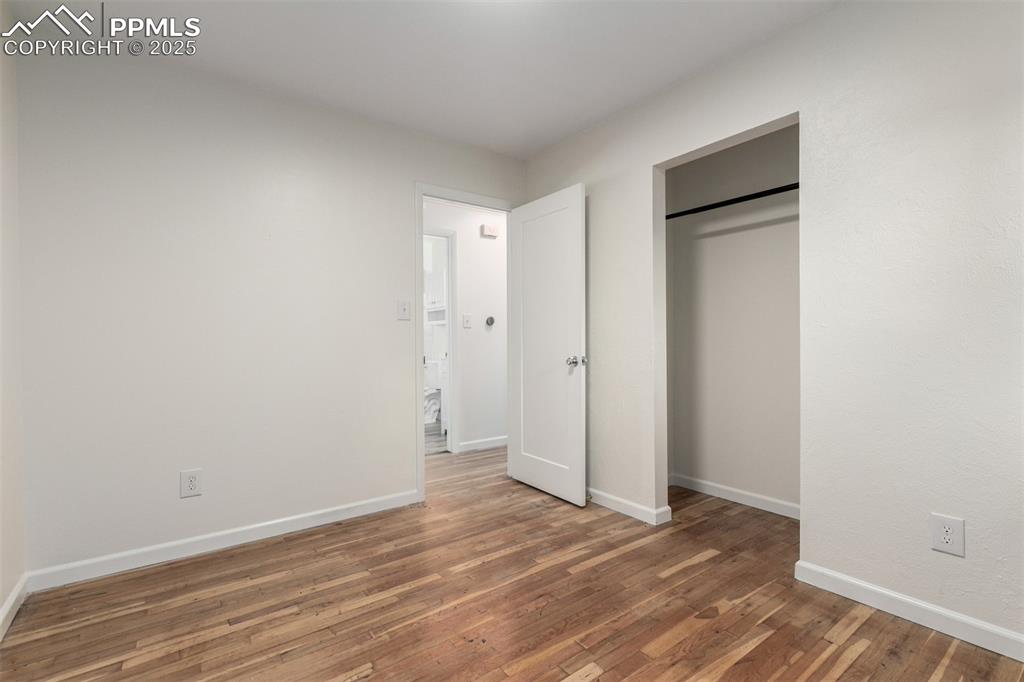 1216 Osgood Road Colorado Springs, CO 80915 - Photo 18 of 36 a view of an empty room with wooden floor and closet
