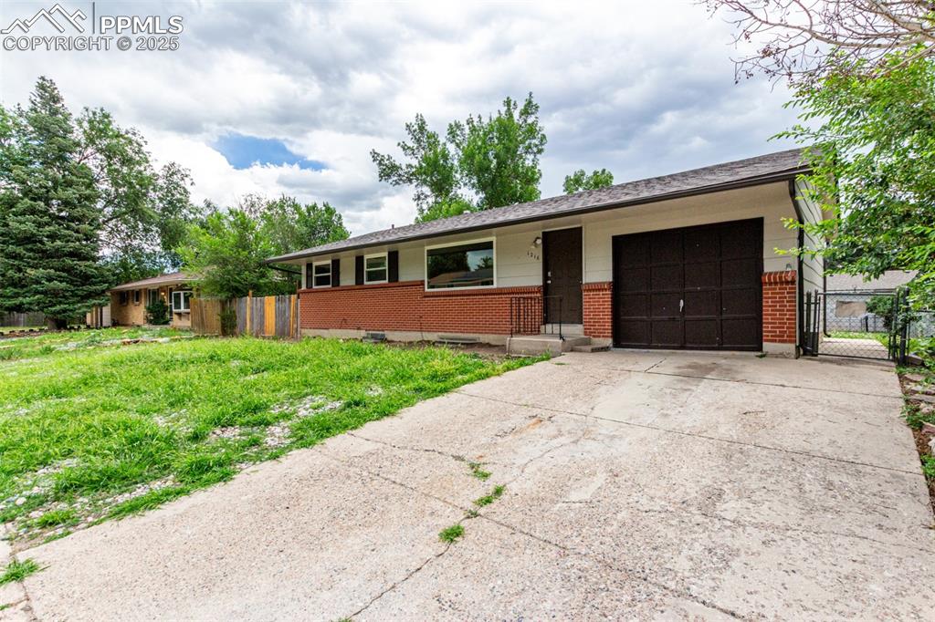 1216 Osgood Road Colorado Springs, CO 80915 - Photo 2 of 36 a front view of house with yard and green space