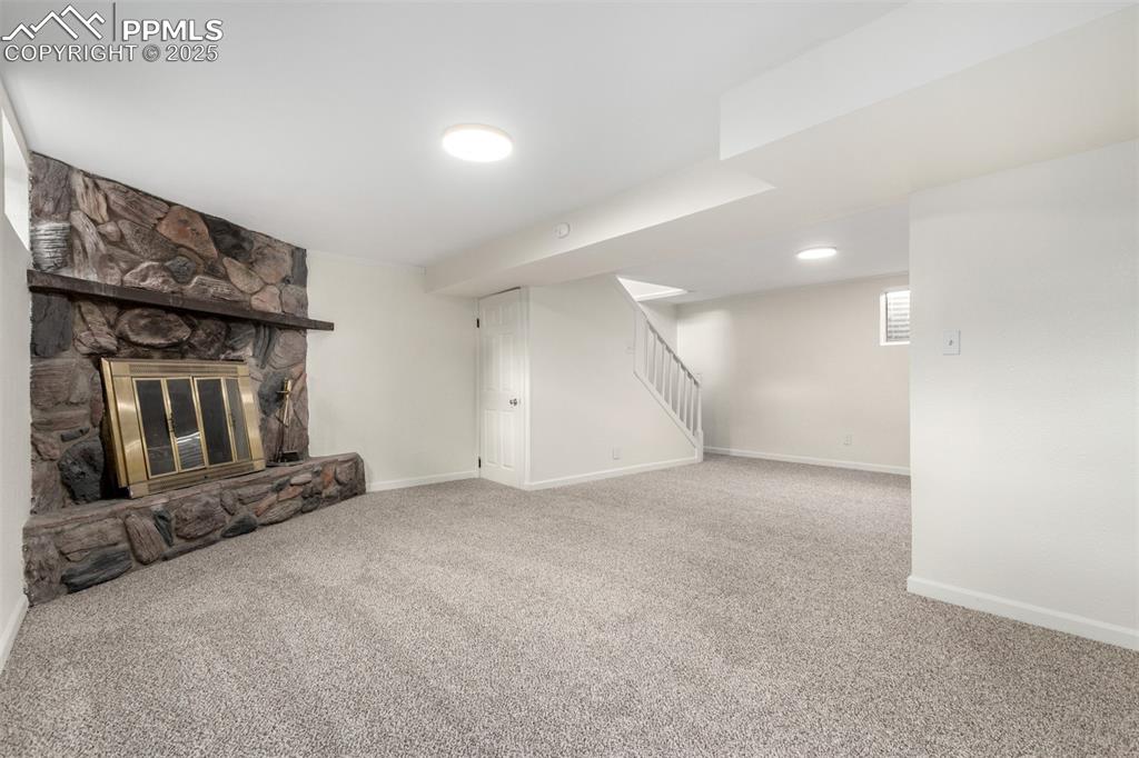 1216 Osgood Road Colorado Springs, CO 80915 - Photo 23 of 36 an empty room with fireplace and windows