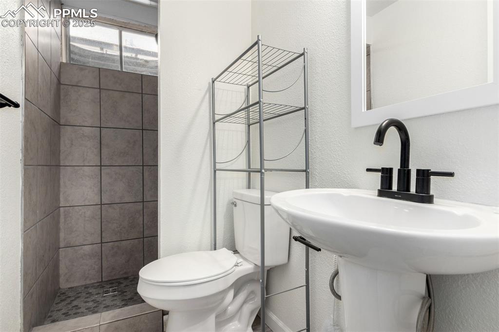 1216 Osgood Road Colorado Springs, CO 80915 - Photo 27 of 36 a bathroom with a sink toilet and shower