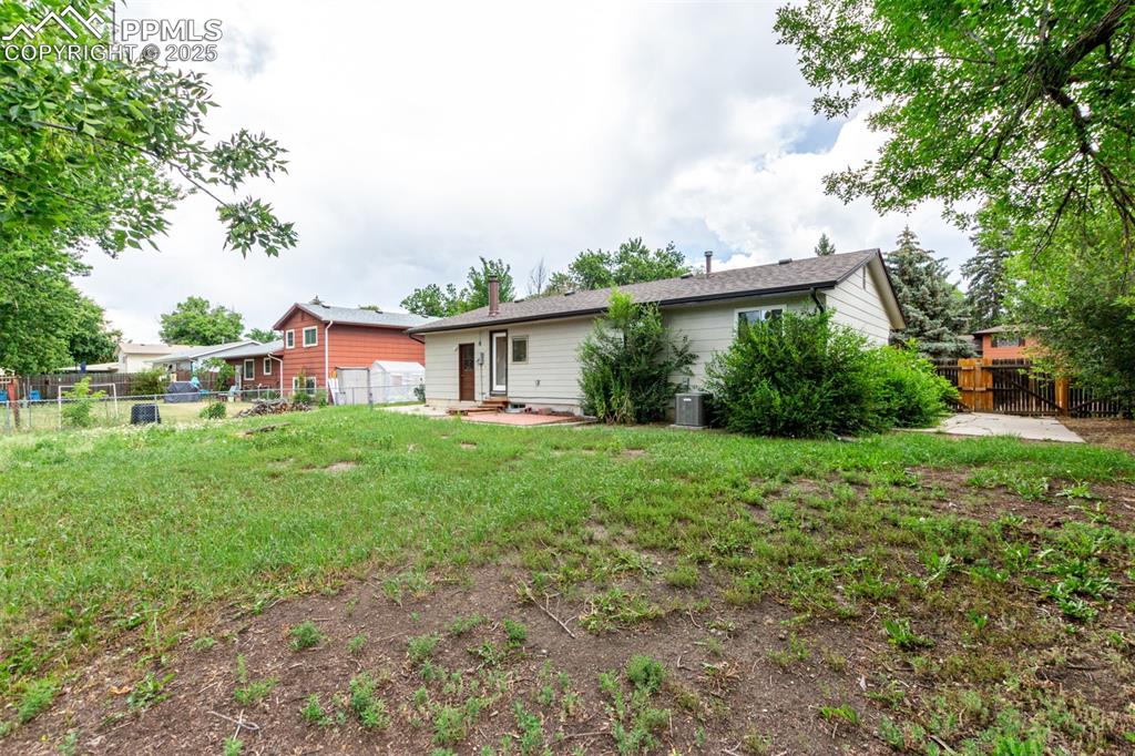 1216 Osgood Road Colorado Springs, CO 80915 - Photo 32 of 36 a view of a house with yard and a garden