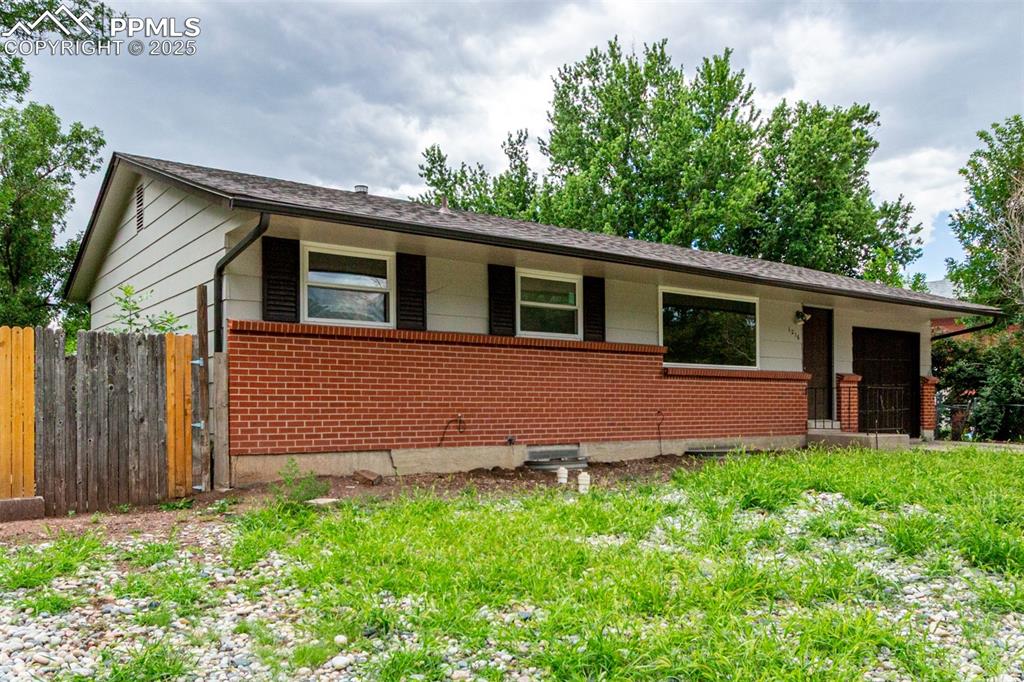 1216 Osgood Road Colorado Springs, CO 80915 - Photo 33 of 36 a front view of house with yard and trees in the background