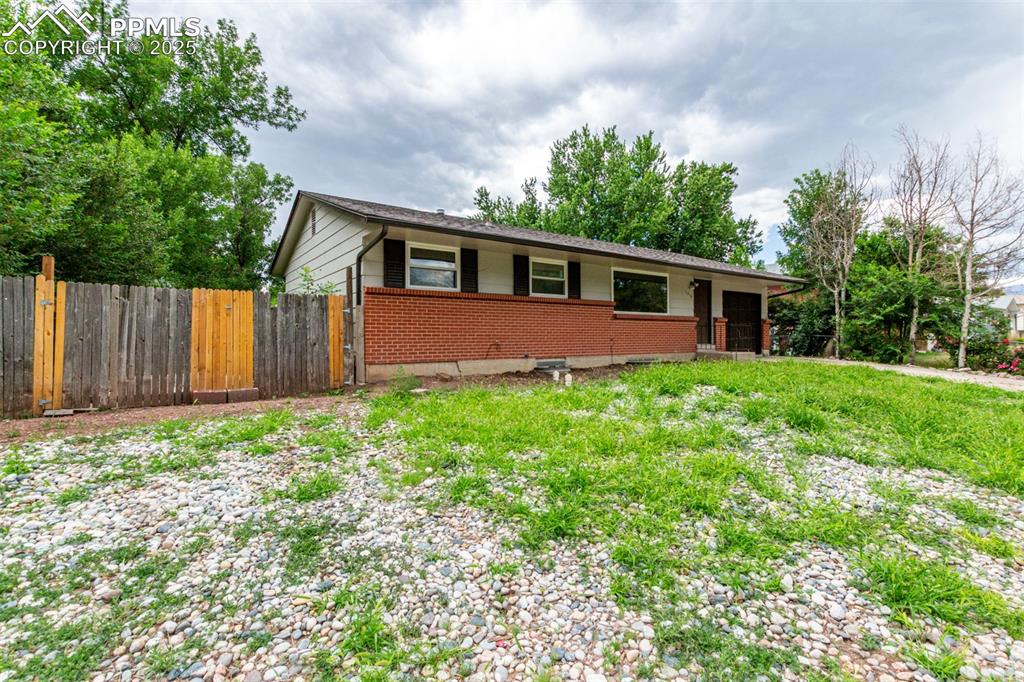 1216 Osgood Road Colorado Springs, CO 80915 - Photo 4 of 36 a front view of house with yard and green space