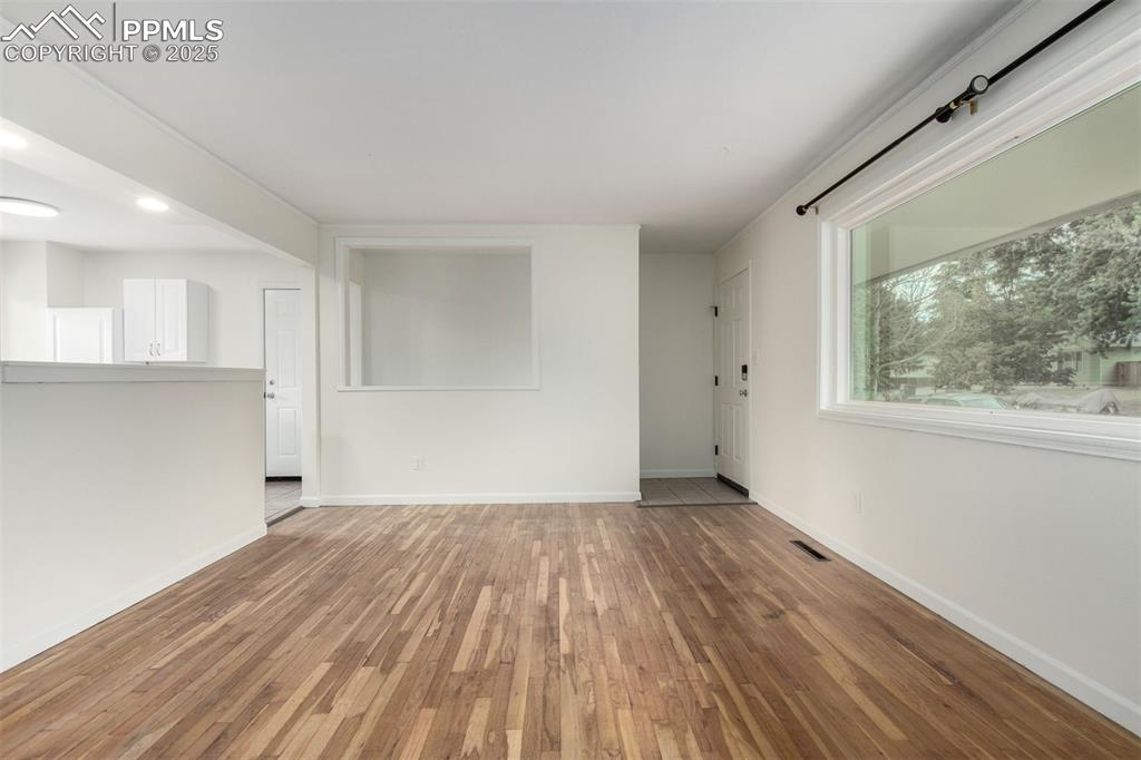 1216 Osgood Road Colorado Springs, CO 80915 - Photo 6 of 36 a view of a room with wooden floors and window