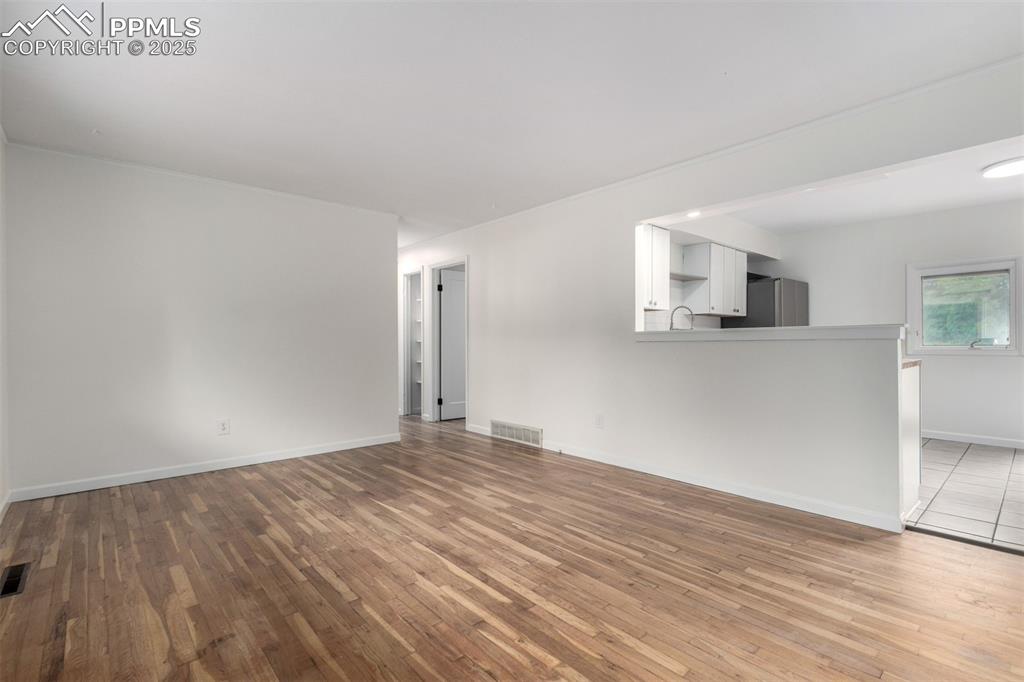 1216 Osgood Road Colorado Springs, CO 80915 - Photo 7 of 36 a view of empty room with wooden floor