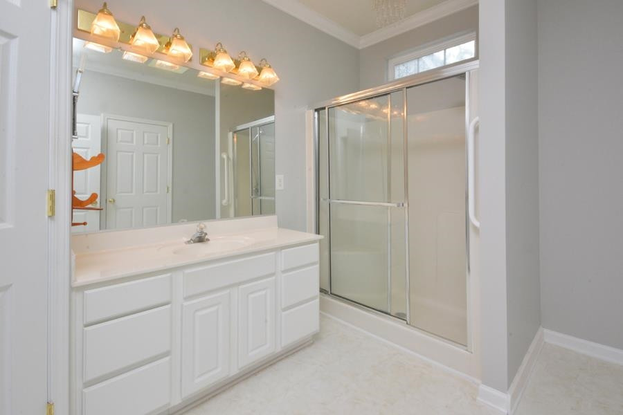 710 Latta Circle Durham, NC 27712 - Photo 12 of 42 a bathroom with a mirror sink and vanity