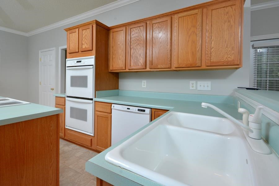 710 Latta Circle Durham, NC 27712 - Photo 25 of 42 a kitchen with stainless steel appliances granite countertop a sink a stove and a refrigerator