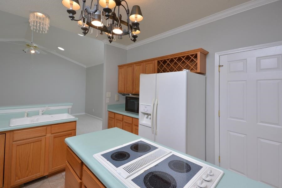 710 Latta Circle Durham, NC 27712 - Photo 31 of 42 a kitchen that has a microwave a stove and a refrigerator
