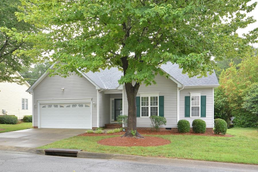 710 Latta Circle Durham, NC 27712 - Photo 41 of 42 a front view of a house with a garden and yard