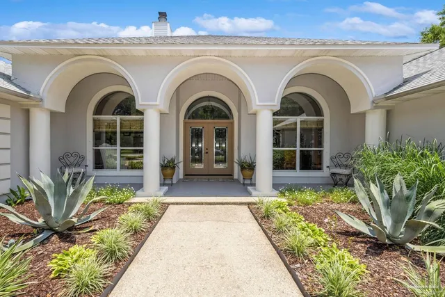 a front view of a house with garden