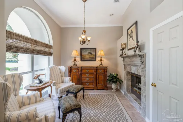 a living room with furniture a chandelier and a large window