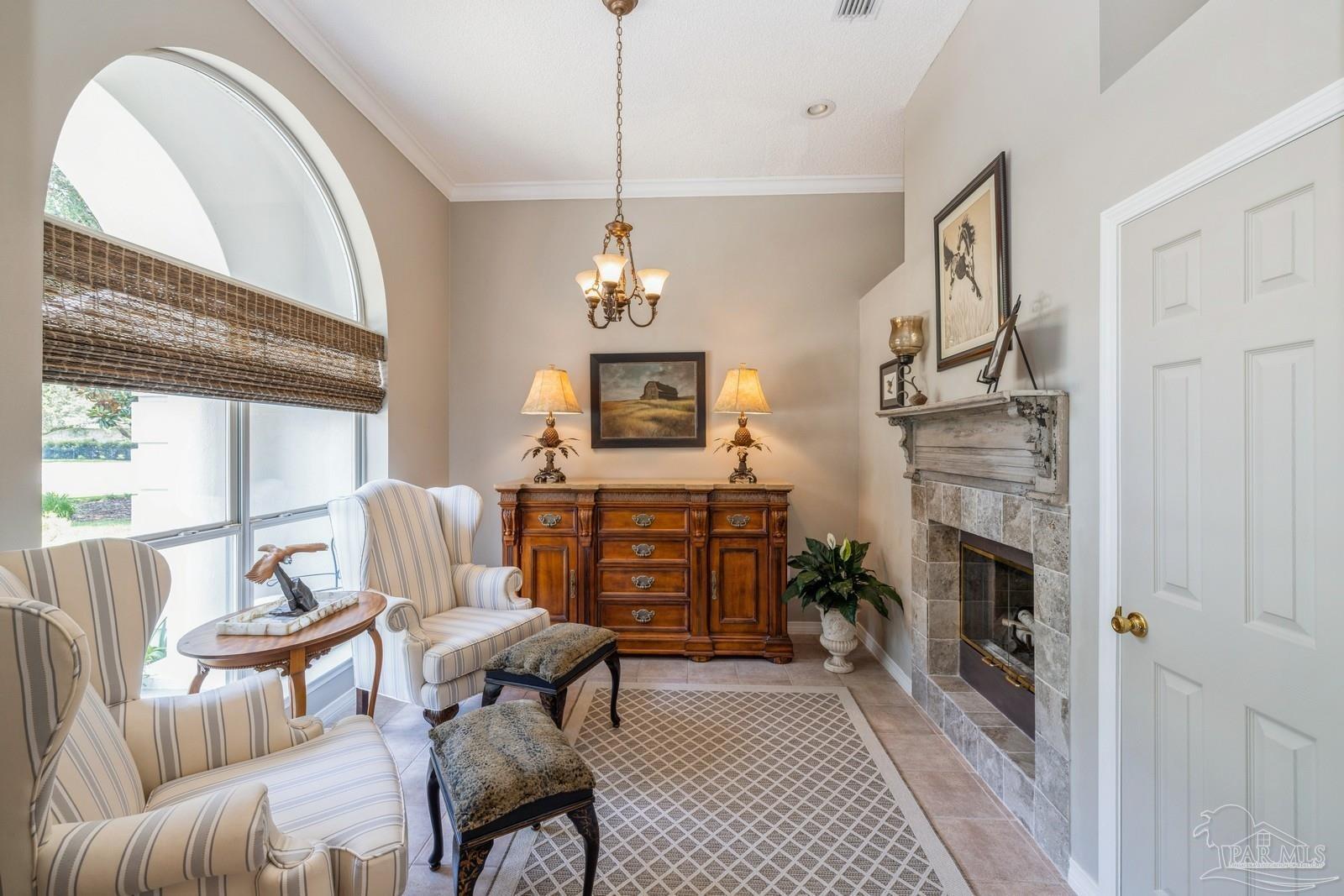2808 P.G.A Boulevard Navarre, FL 32566 - Photo 11 of 54 a living room with furniture a fireplace and a flat screen tv