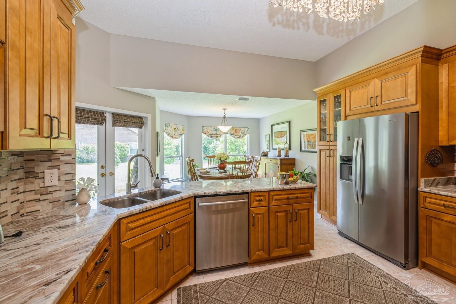 2808 P.G.A Boulevard Navarre, FL 32566 - Photo 14 of 54 a kitchen with stainless steel appliances granite countertop a refrigerator and a sink