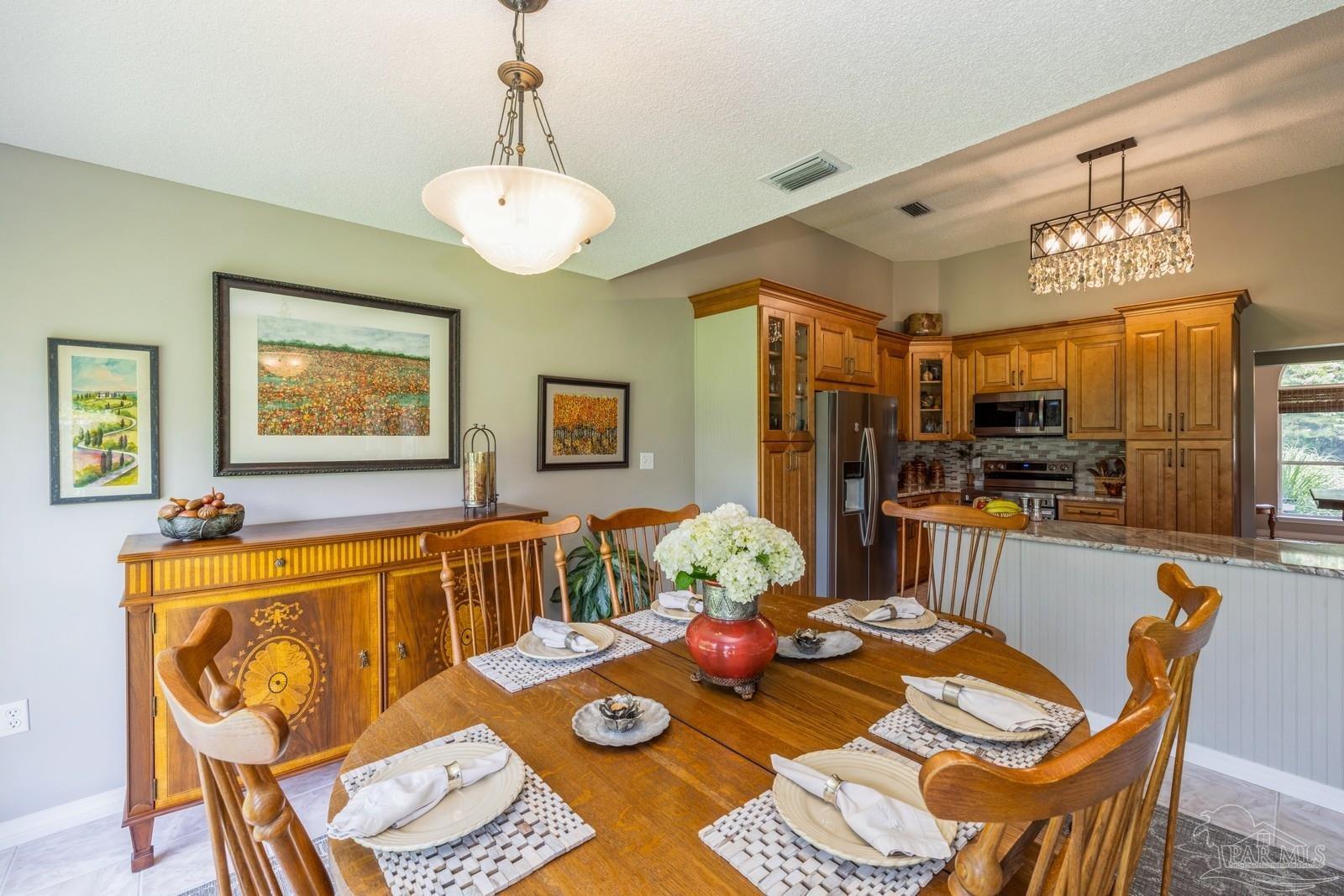 2808 P.G.A Boulevard Navarre, FL 32566 - Photo 20 of 54 a view of a dining room with furniture