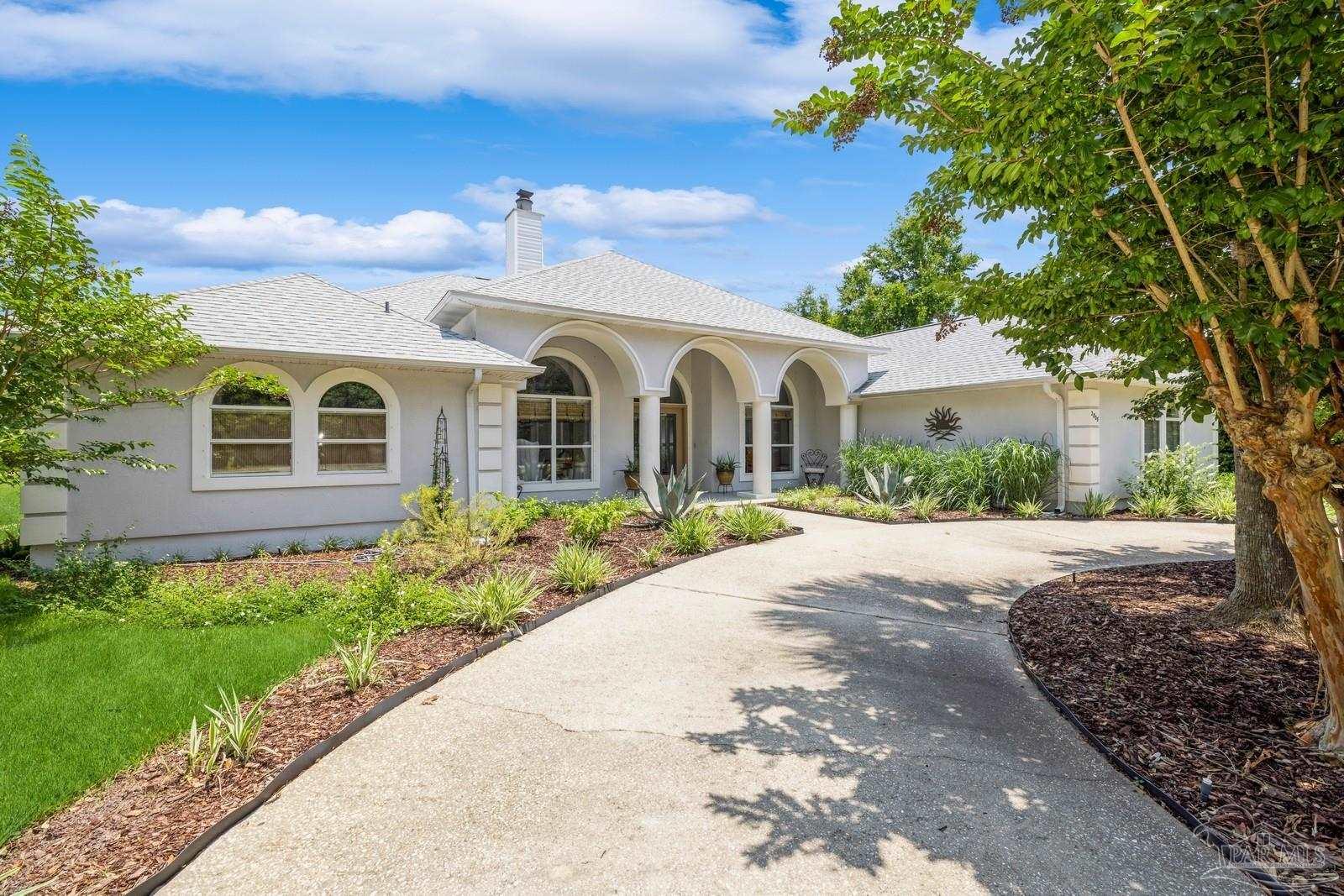2808 P.G.A Boulevard Navarre, FL 32566 - Photo 2 of 54 a front view of a house with garden