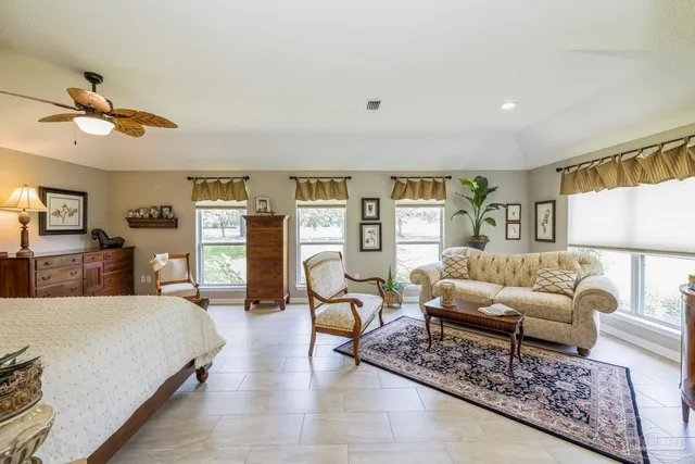 a bedroom with furniture and a wooden floor