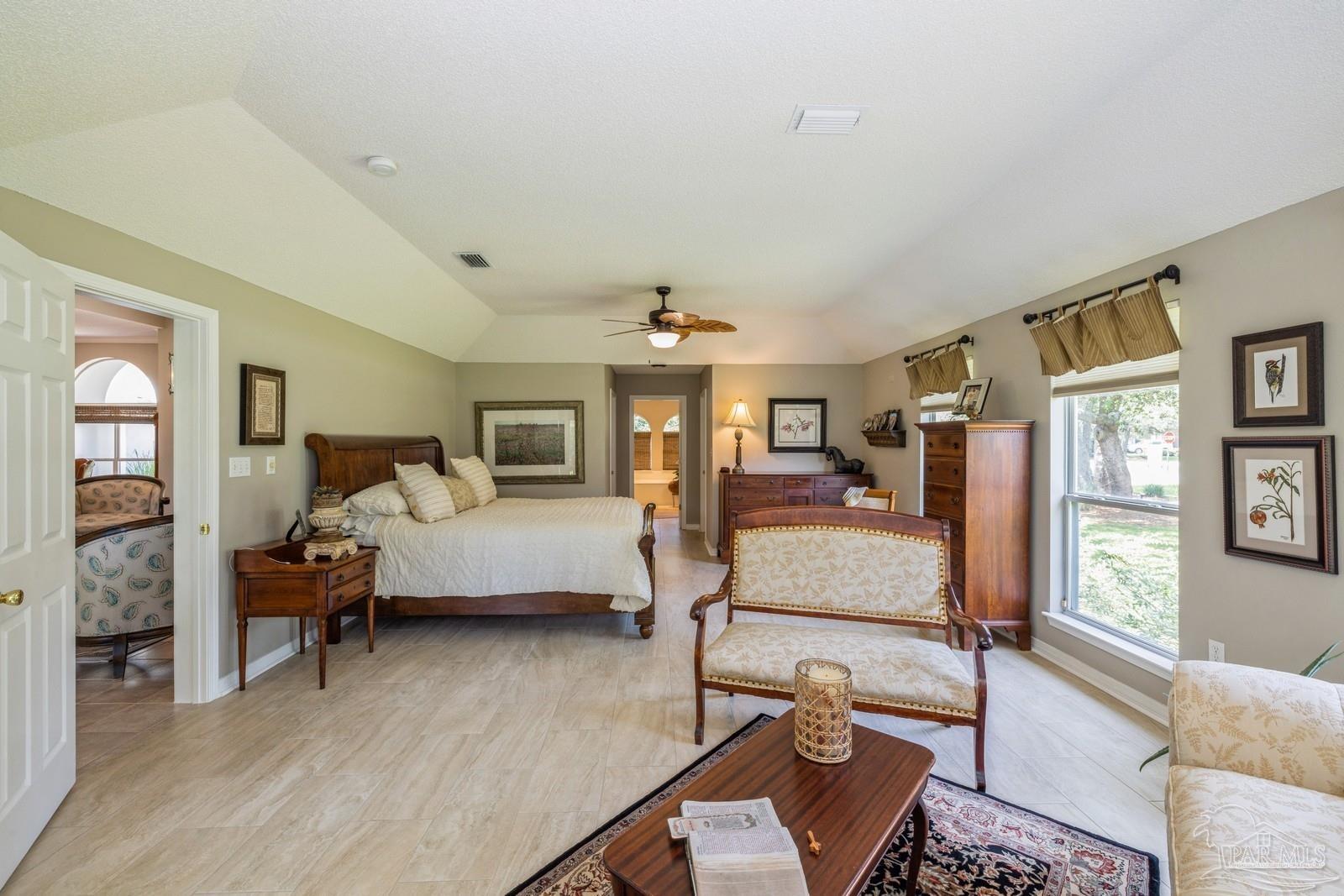 2808 P.G.A Boulevard Navarre, FL 32566 - Photo 22 of 54 a bedroom with furniture and a wooden floor