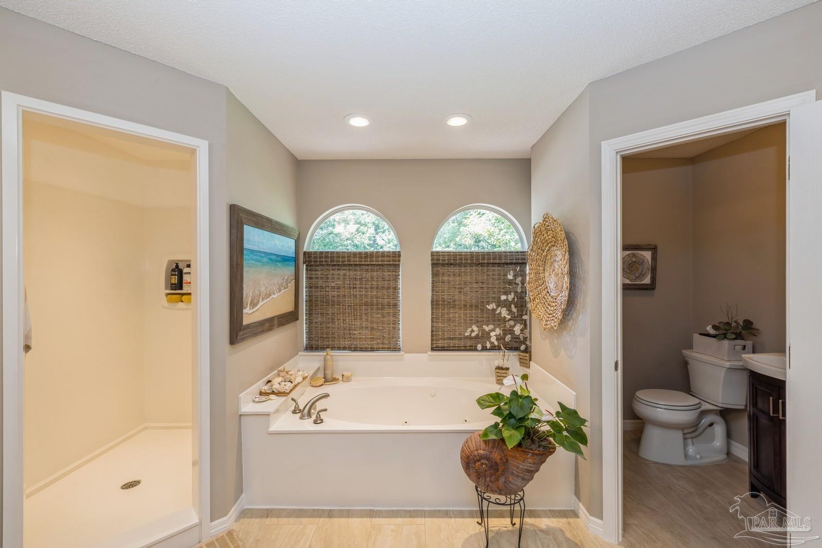 2808 P.G.A Boulevard Navarre, FL 32566 - Photo 25 of 54 a bathroom with a bathtub and a shower