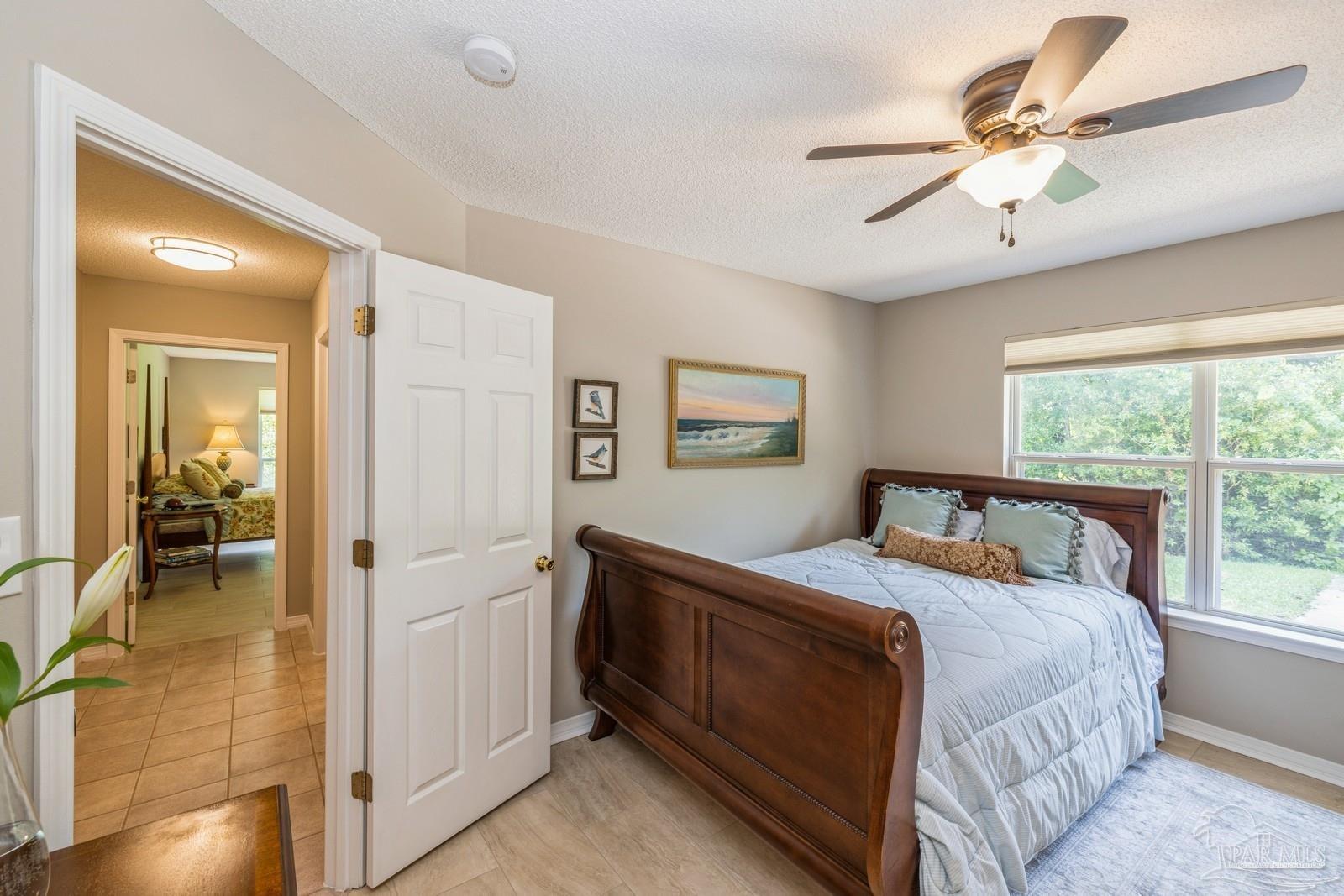 2808 P.G.A Boulevard Navarre, FL 32566 - Photo 30 of 54 a bedroom with a bed and a chandelier