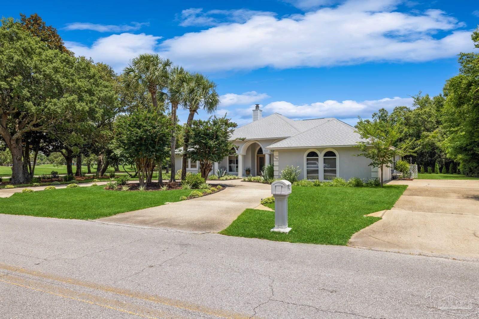 2808 P.G.A Boulevard Navarre, FL 32566 - Photo 3 of 54 a front view of a house with a yard and garage