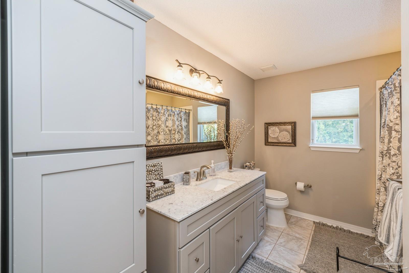 2808 P.G.A Boulevard Navarre, FL 32566 - Photo 31 of 54 a bathroom with a sink and a mirror