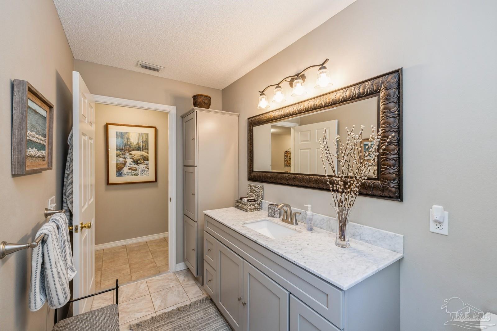 2808 P.G.A Boulevard Navarre, FL 32566 - Photo 32 of 54 a bathroom with 2 sink and a mirror
