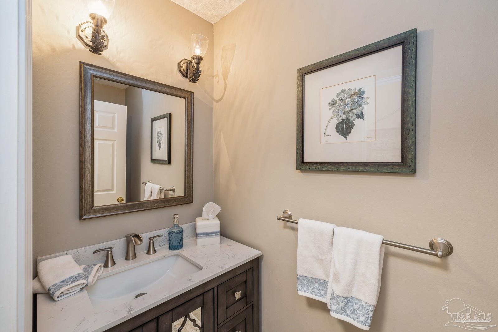2808 P.G.A Boulevard Navarre, FL 32566 - Photo 35 of 54 a bathroom with a sink mirror and vanity