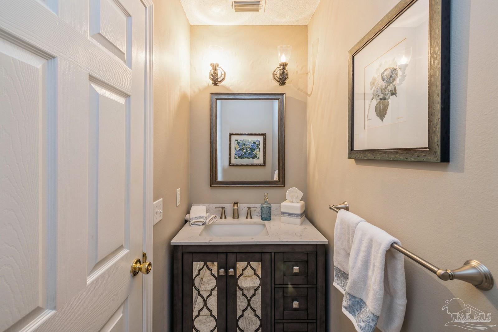 2808 P.G.A Boulevard Navarre, FL 32566 - Photo 36 of 54 a bathroom with a sink and a mirror